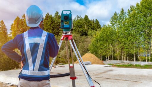 Surveyor using a camera to document a forest area.
