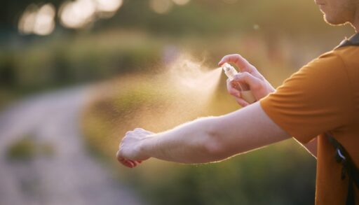 Man applying insect repellent to his arm.