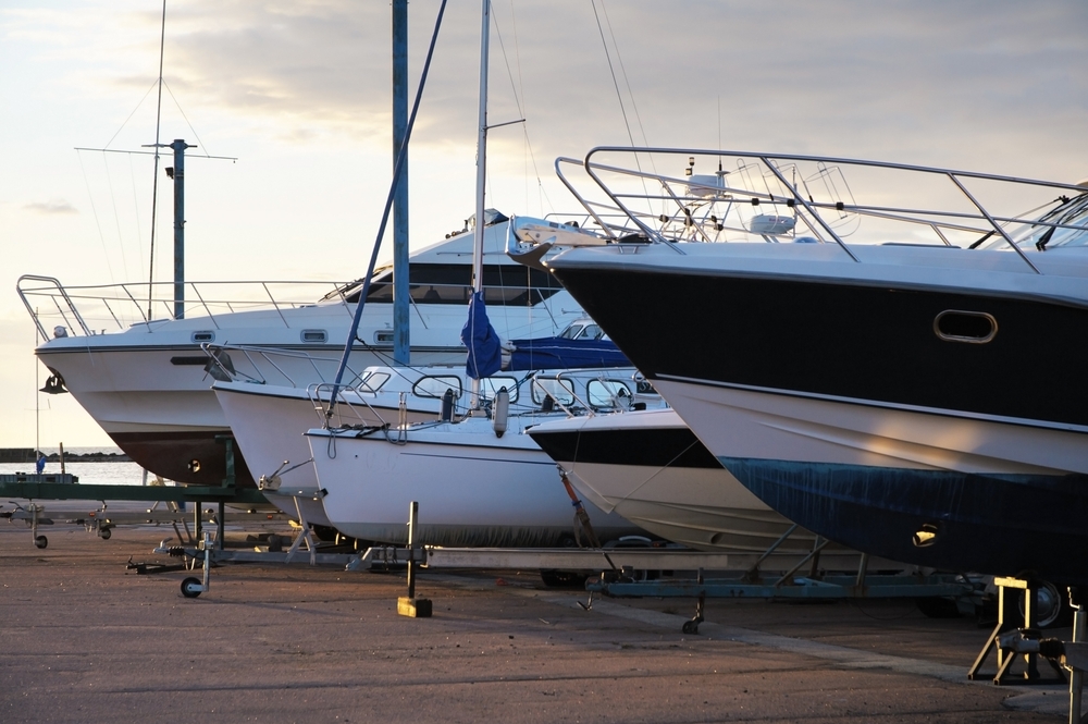 Close-up of boats for sale lined up along a dock.
