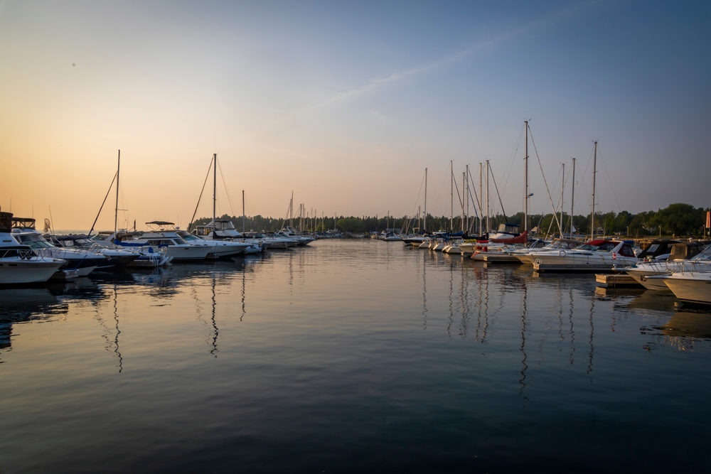 Boats anchored at a pier during sunset.