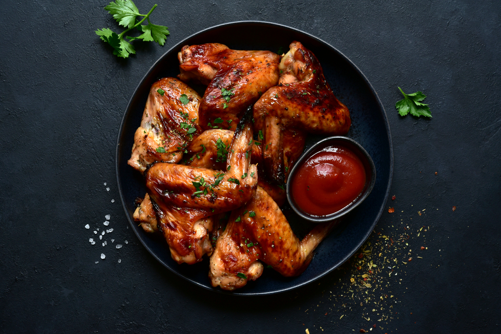 Overhead view of spicy barbecued chicken wings.