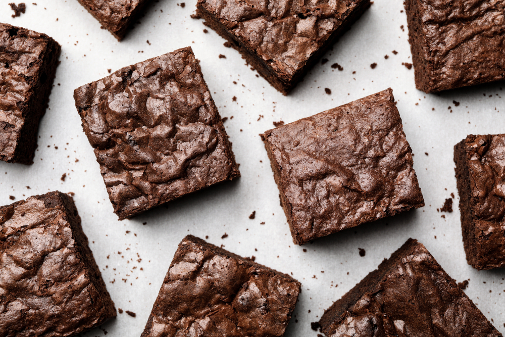 Overhead view of fudgy brownies on a white background.