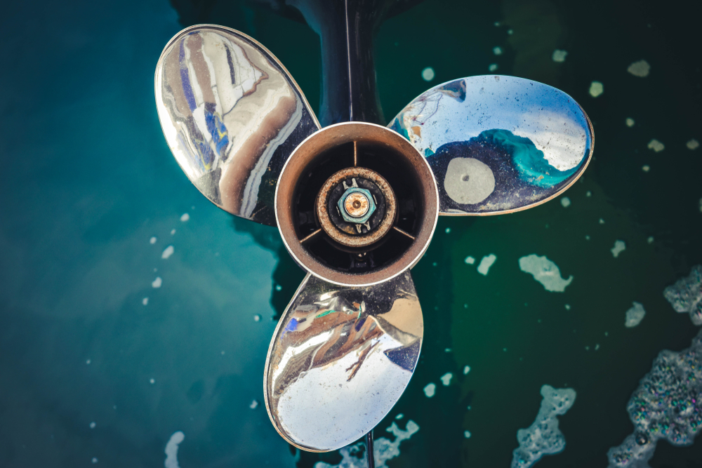 Close-up of three blades on a boat engine.