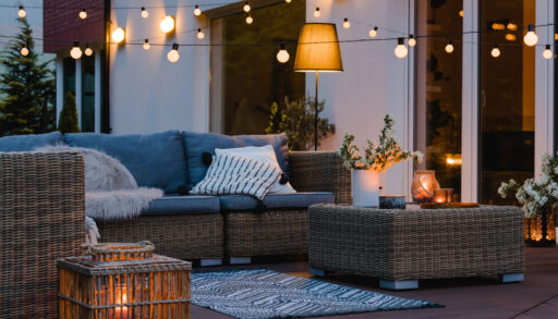 Newly renovated patio in the evening with lights hung over top.