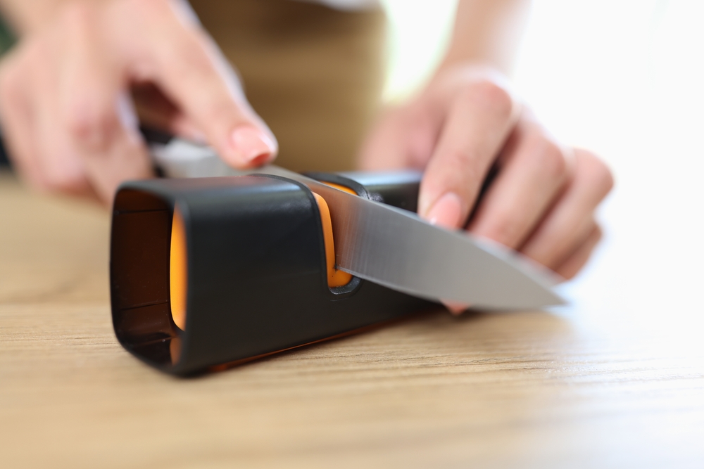 Person sharpening a knife.