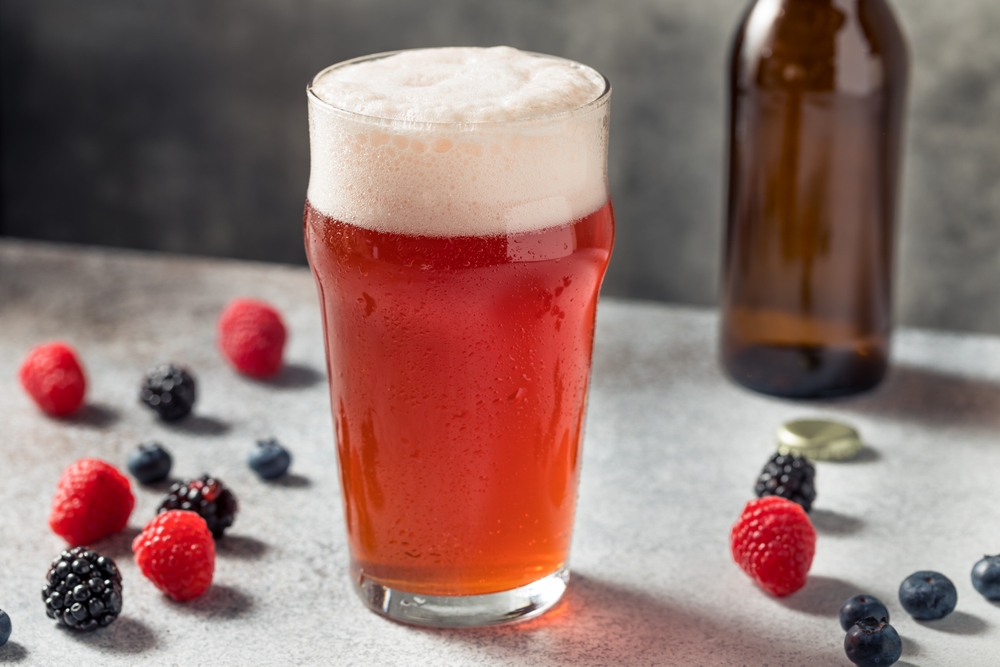 Red-coloured beer shandy in a pint glass.
