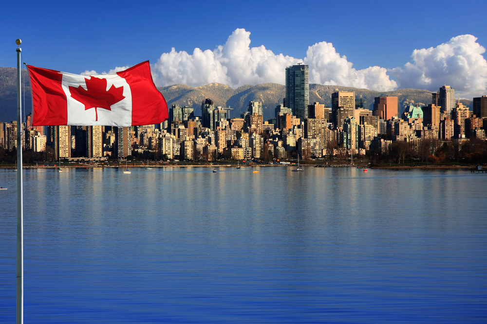 Canadian flag in front of Vancouver, British Columbia, Canada.