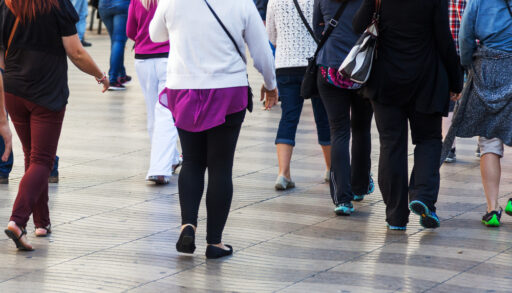 Crowd of people walking in a city.