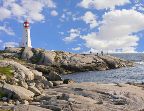 Red and white lighthouse on the rocky shores of Peggy's Cove, Nova Scotia, Canada.