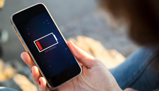 Close-up of a person's phone screen with a low battery indicator.