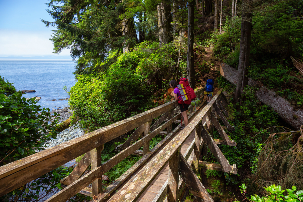 Woman standing on a bridge along the Juan de Fuca Trail, Vancouver Island, B.C.