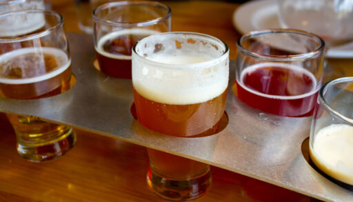 Glasses of beer in a serving tray.