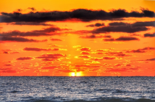 Bright orange sunset over Lake Huron near Sauble Beach, Ontario.