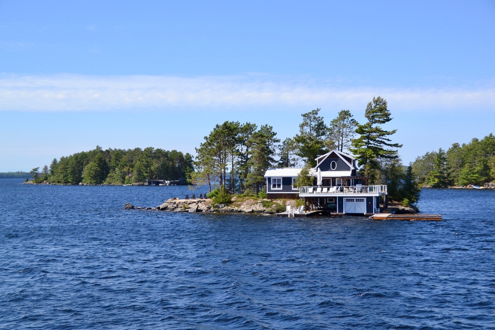 Brown cottage on an island on Lake Muskoka.
