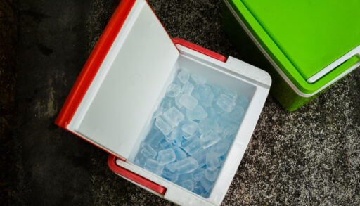 Red drink cooler filled with ice.