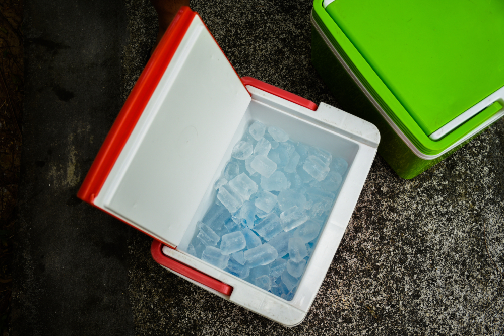 Red drink cooler filled with ice.