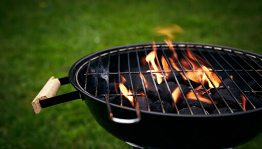 Close-up of a small black grill with flames.