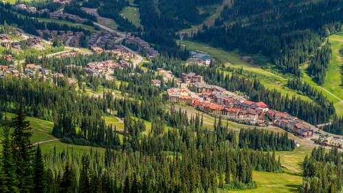 View of the Sun Peaks Resort village nestled in a green valley in central B.C.
