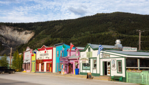 Dawson City, Yukon. Small town with colorful shop exteriors in a forest landscape.