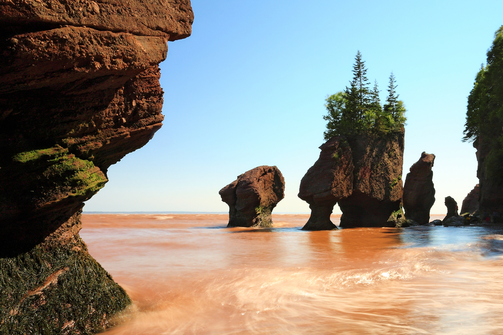 Unique rock formations along the shore of a water body.