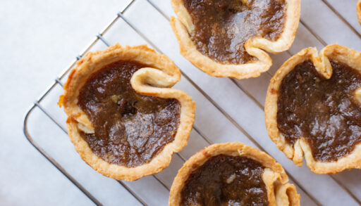 Butter tarts on a cooling rack.