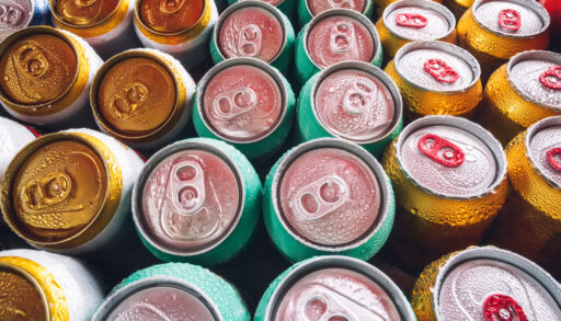 Multi-coloured beer cans lined up in rows.