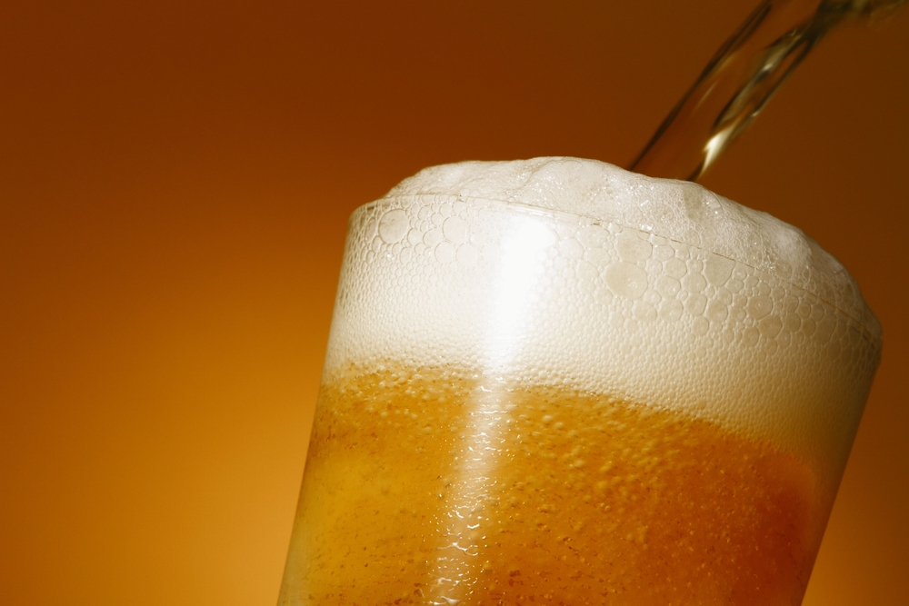 Close-up of Ale being poured into a beer glass.