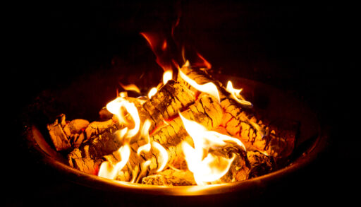 Close-up of a burning campfire at night.