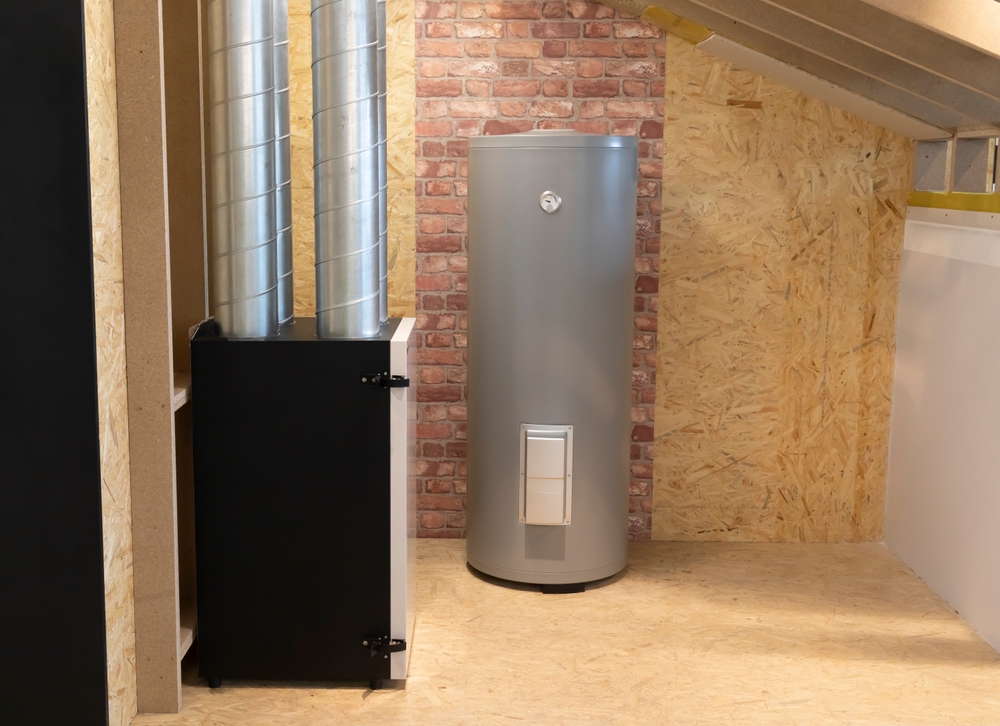Grey hot water tank in an unfinished basement.