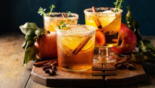 Apple cider prepared on a wooden board.
