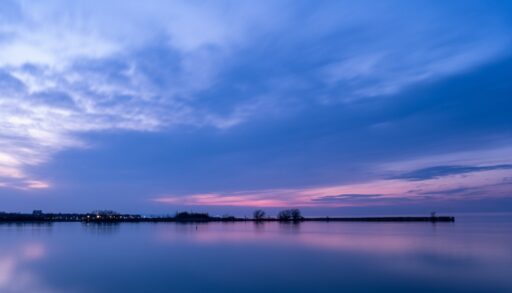 Lake Huron at sunset. The sky is shades of blue, purple, and pink.