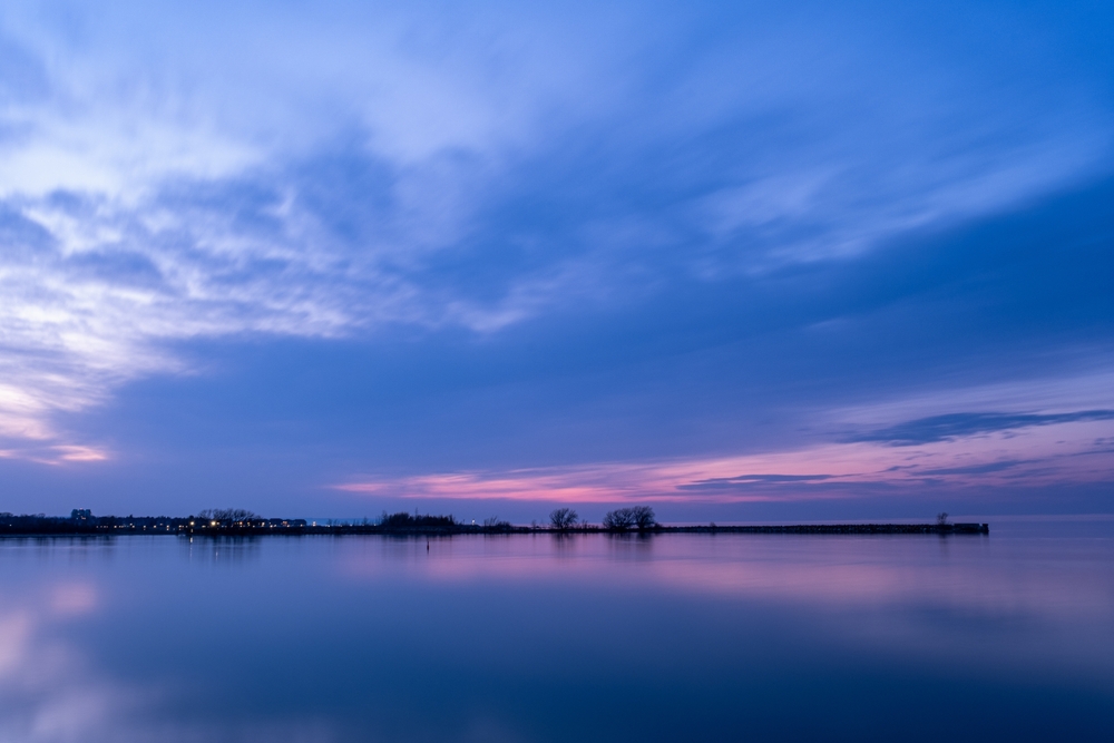 Lake Huron at sunset. The sky is shades of blue, purple, and pink.
