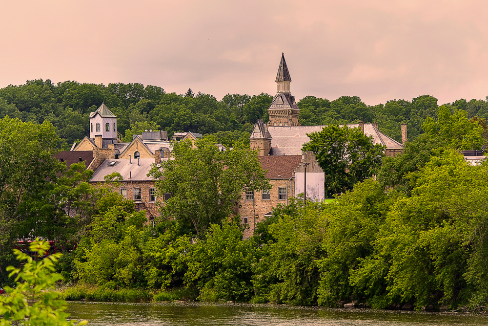 View on an old building surrounded by a forest landscape at sunset in Paris, Ontario, Canada.