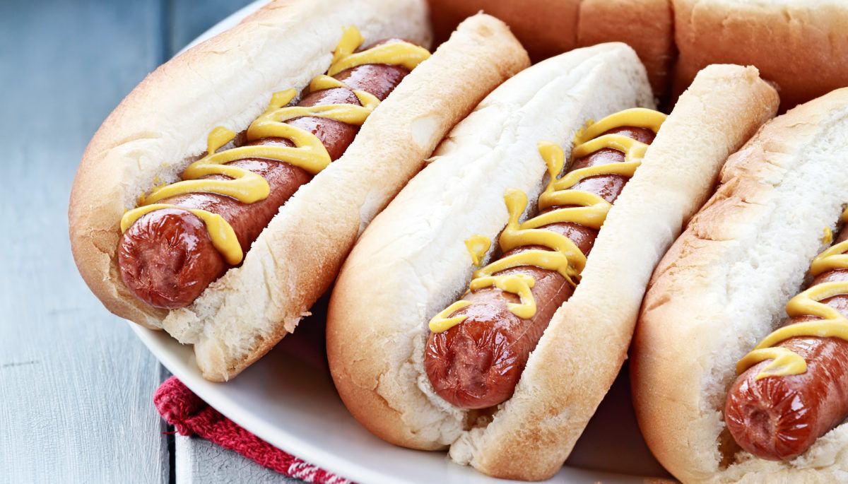 Plate of freshly grilled hotdogs with mustard