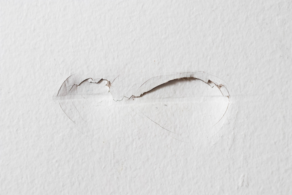 A portion of damaged drywall