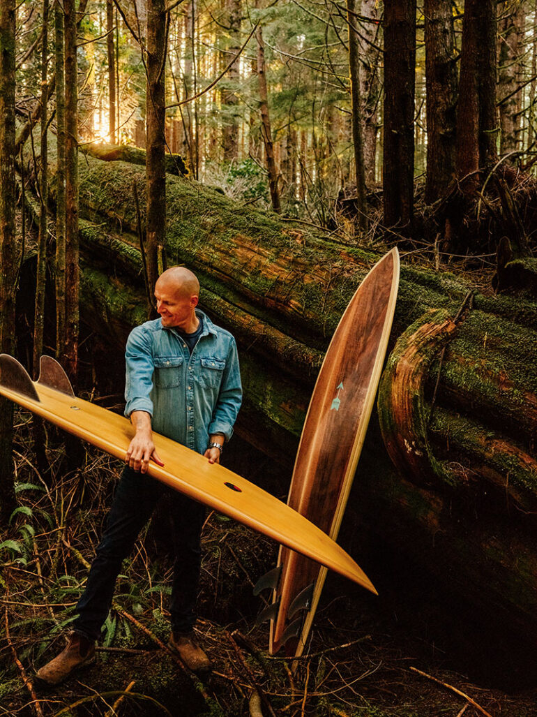 Kamil Bialous holding a surfboard