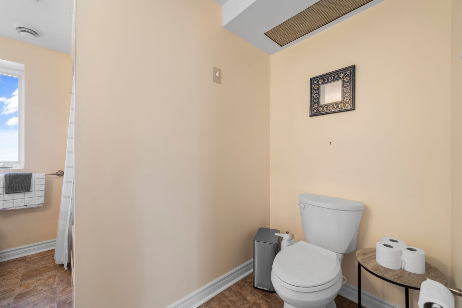A three-piece bathroom with a shower-tub combo, a toilet, and a sink.