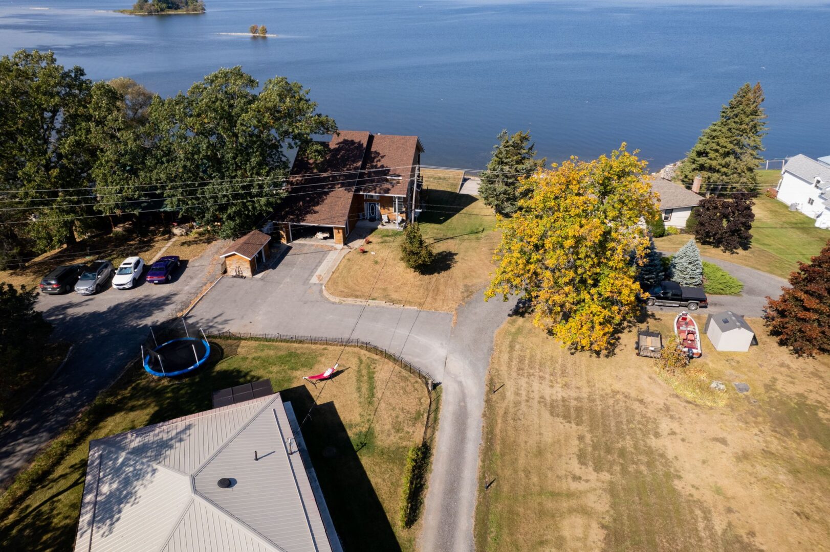 A short road leads down from a home to a waterfront area.