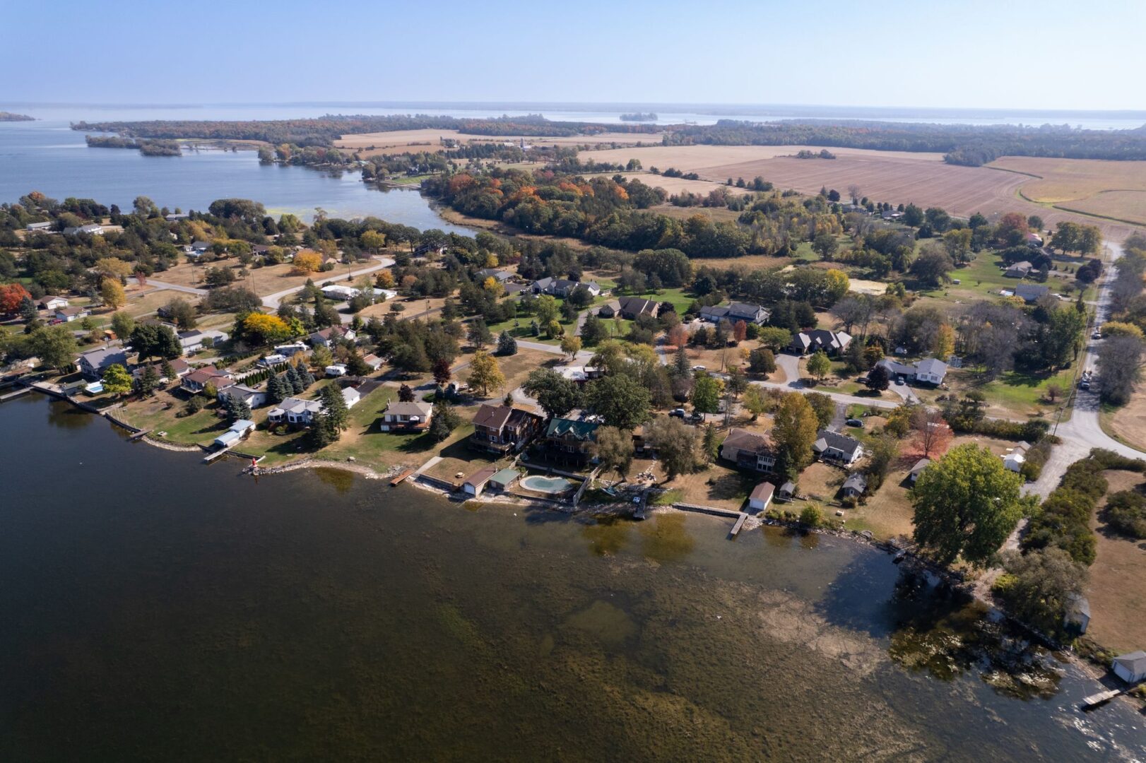 Overhead view of a peninsula of land on the Bay of Quinte, populated with properties.
