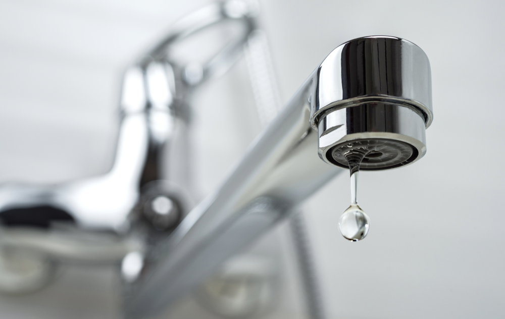 A close up of a dripping tap