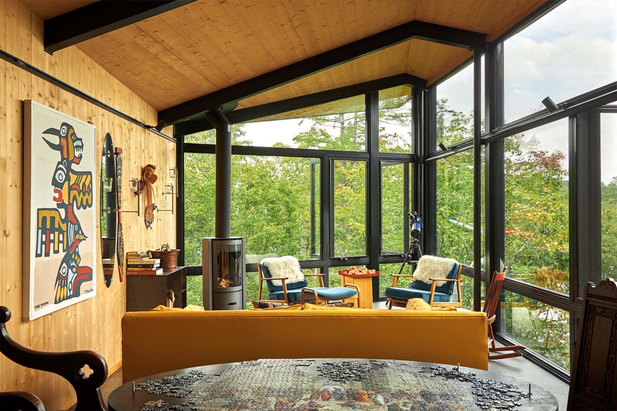A sunny room in the bat cabin that features a table with a jigsaw puzzle and the cozy living room