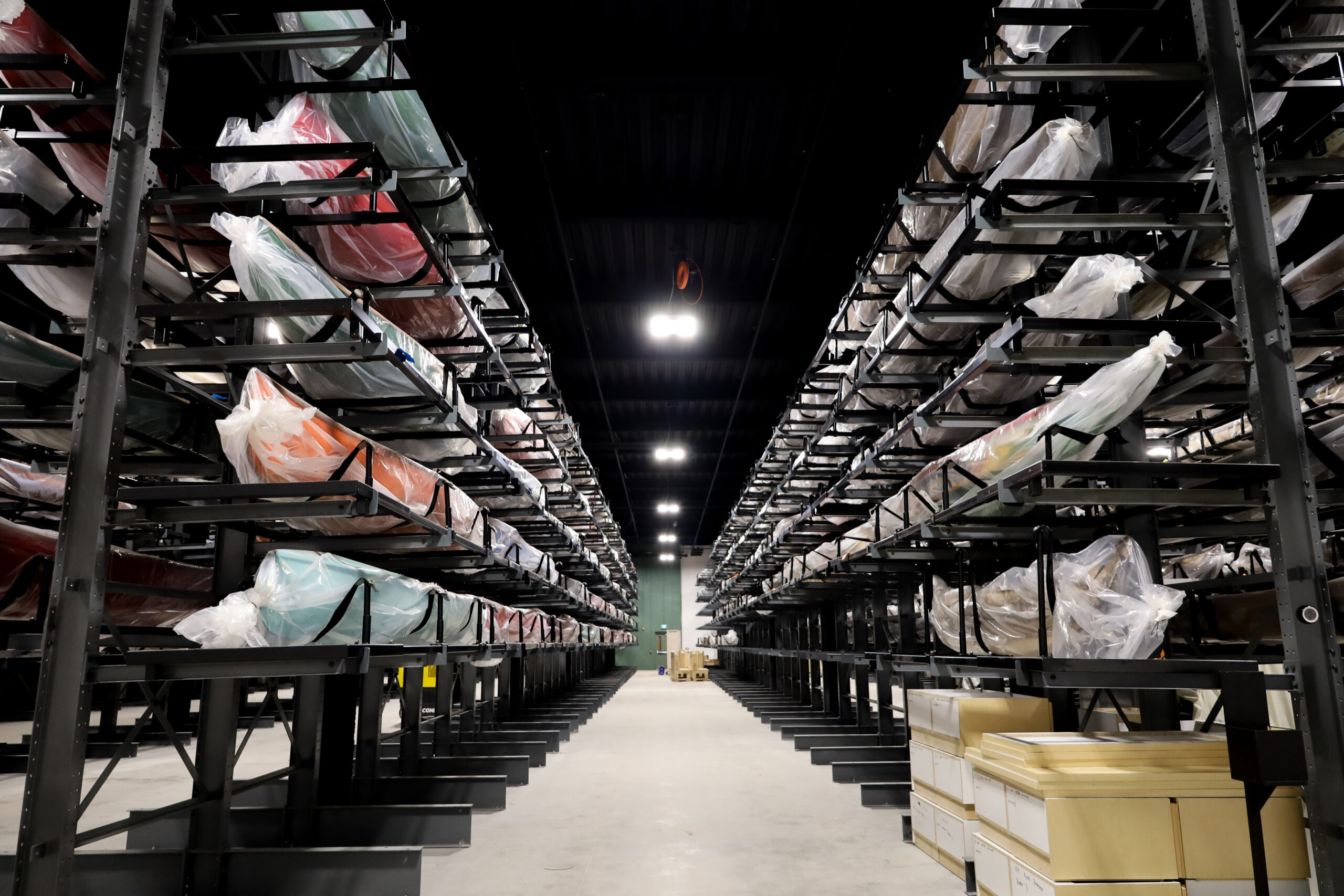 The Canadian Canoe Museum's collection hall, filled with vessels stacked in racks