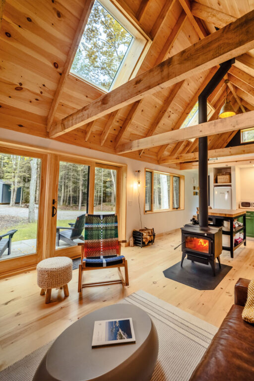 Interior of a cottage with a woodstove and a skylight in the roof panel