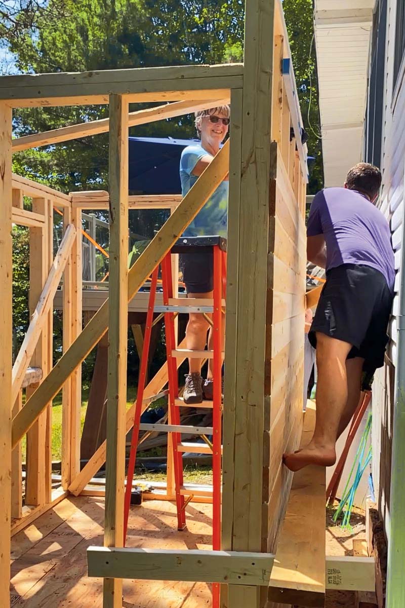 two people building a sauna