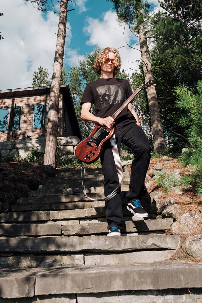 Callahan with his guitar walking down the stairs