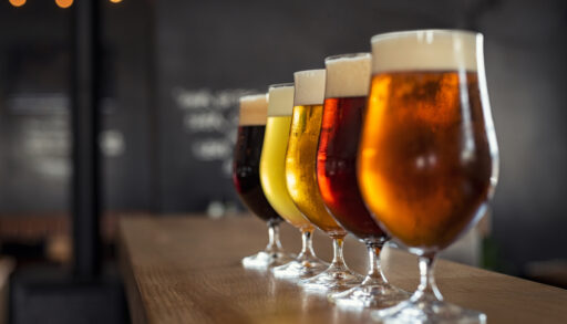 beer glasses lined up on a bar