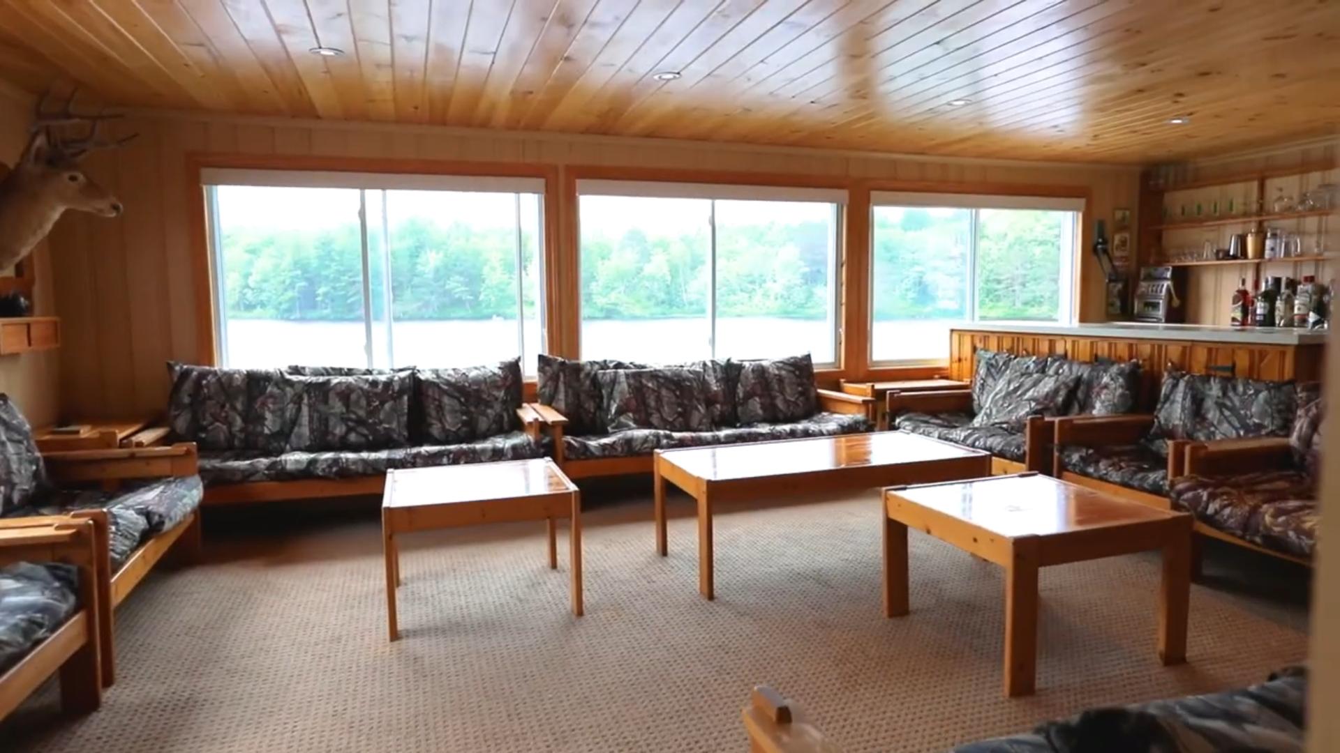 Wood tables face couches with grey cushions