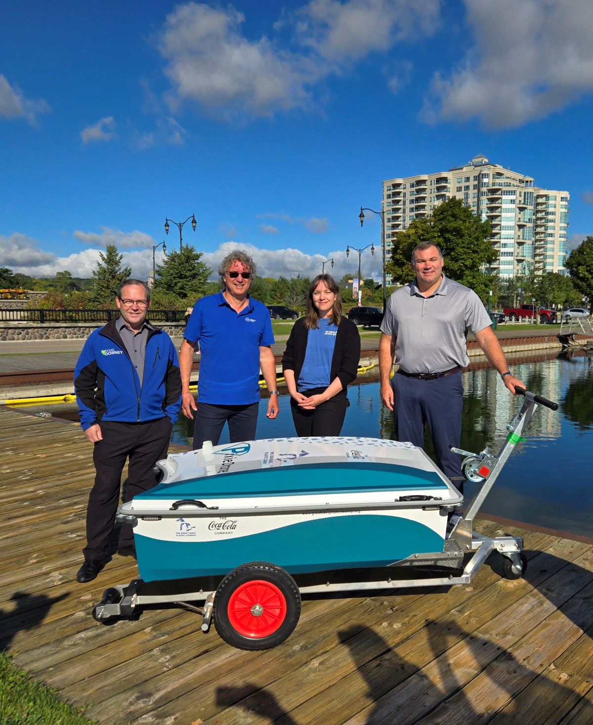 Pollution Probe employees stand with the mayor of Barrie in front of the PixieDrone, a garbage-collecting drone near Lake Simcoe
