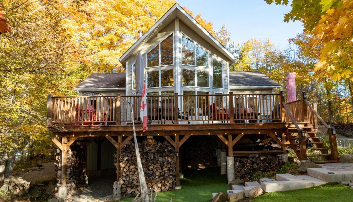 A viceroy-style cottage with huge windows and a large deck on stilts
