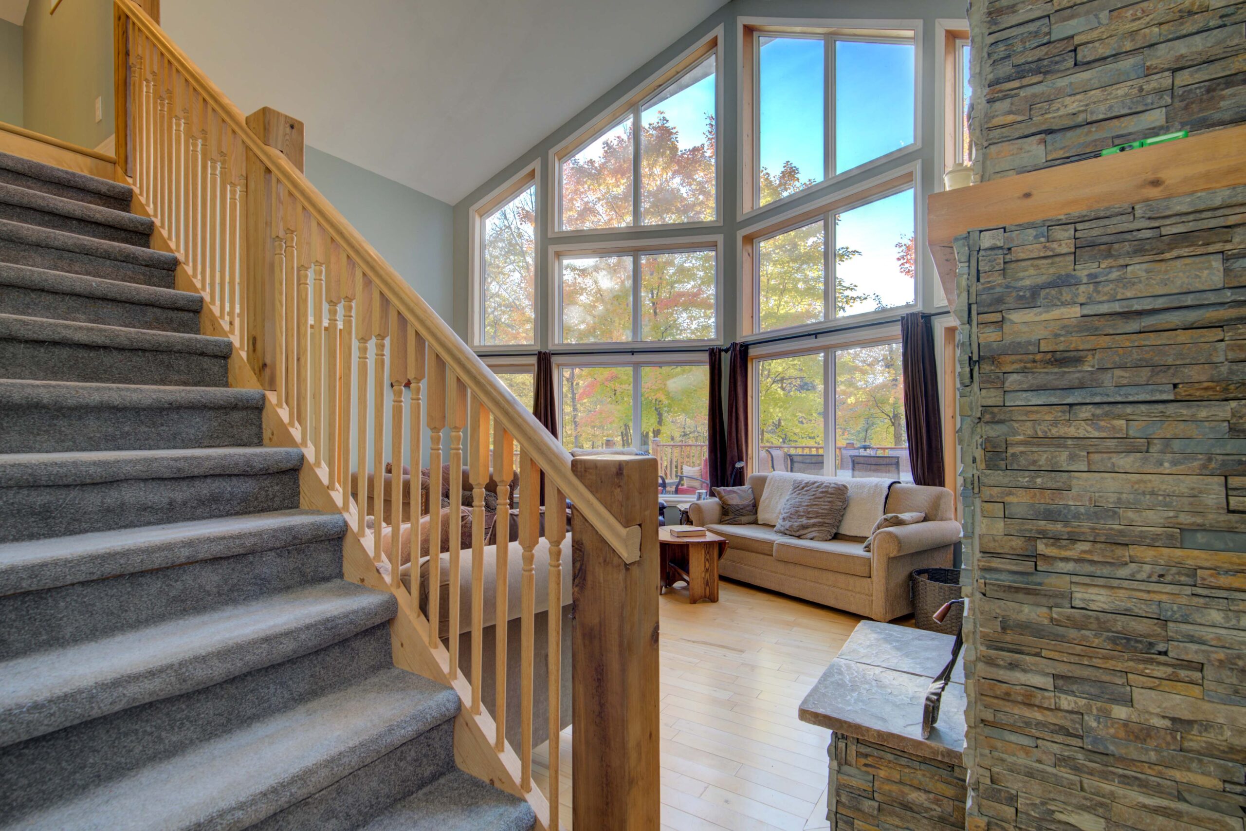 A staircase with grey steps in a huge living room